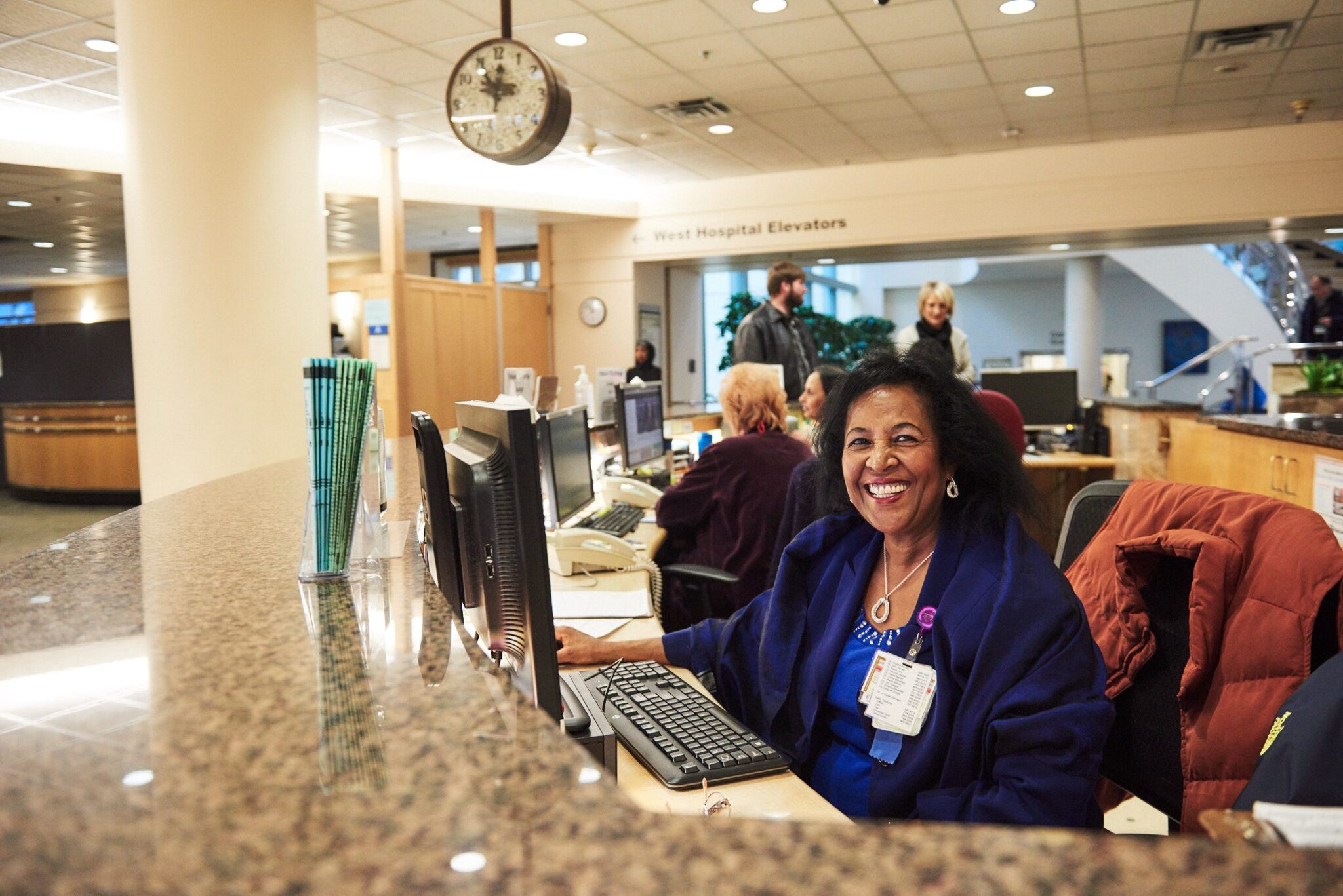 Tita Begashaw working at Harborview's Information Desk 