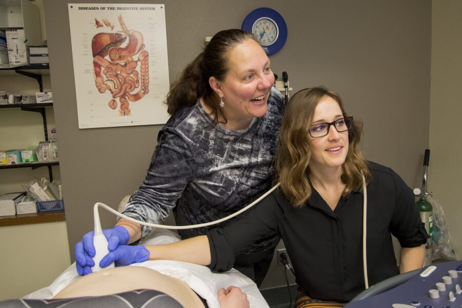 Dr. Anne Millard (left) instructs a student at the Glasgow Clinic in Montana