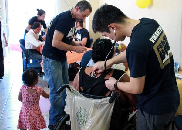 Dr. Chiu listens to a patient's breathing