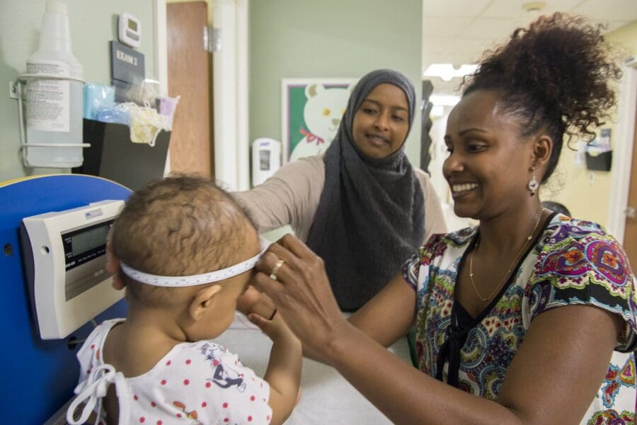 nurse taking care of baby at HMC pediatric clinic