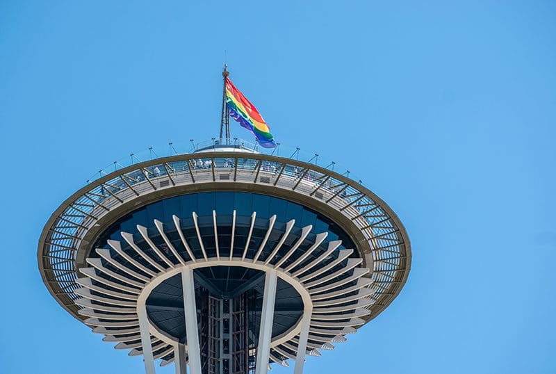 The Space Needle flying a rainbow pride flag.