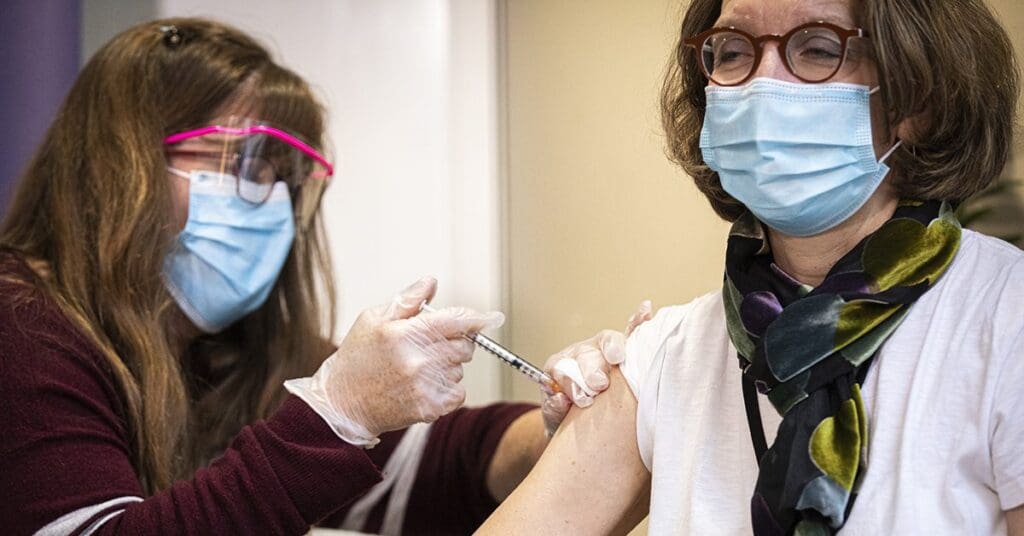 Patricia Kritek receiving the COVID-19 vaccine