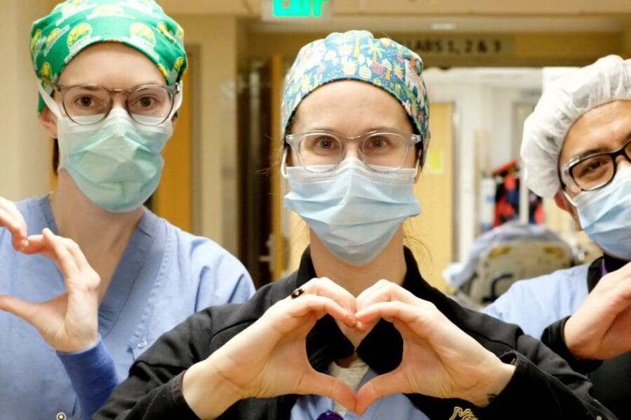 Heart Institute nurses in scrubs making heart hands