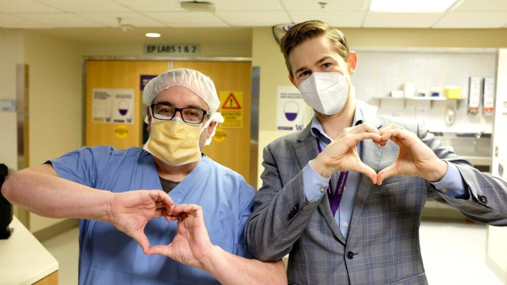 Heart Institute employees make heart hands