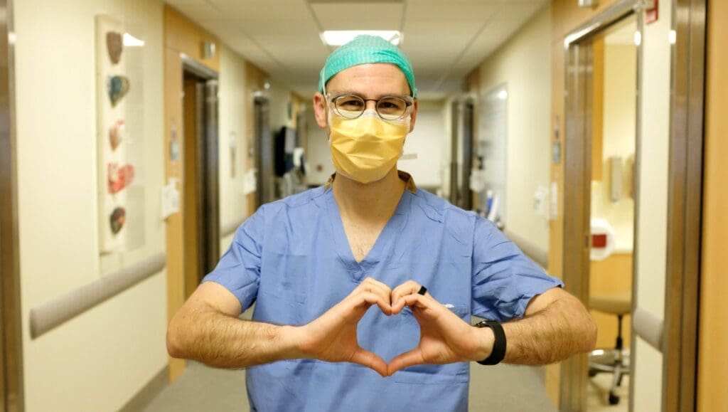 Heart Institute employee making heart with hands