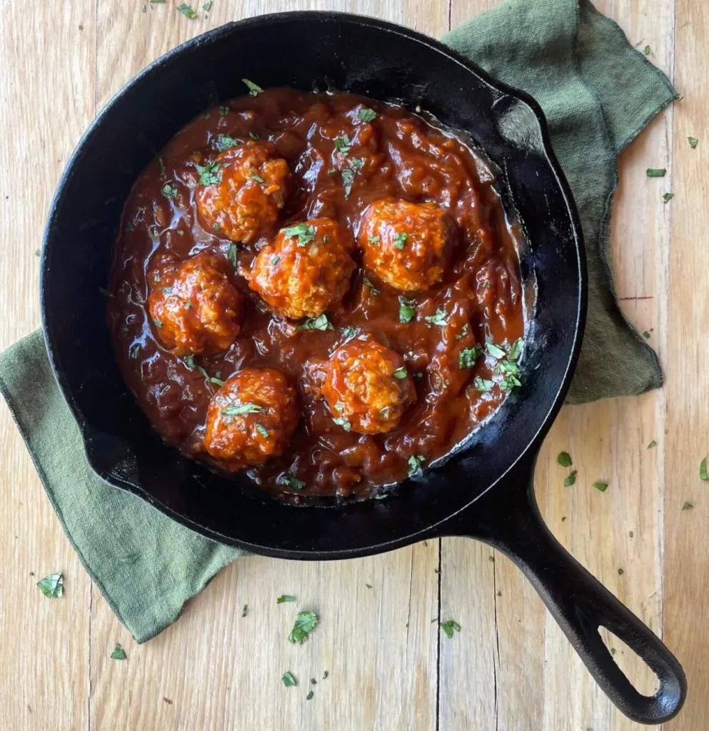 BBQ chicken meatballs shown in a pan