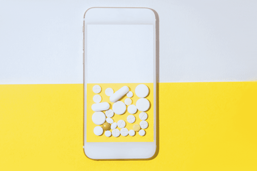 An image of a phone with pills on the screen