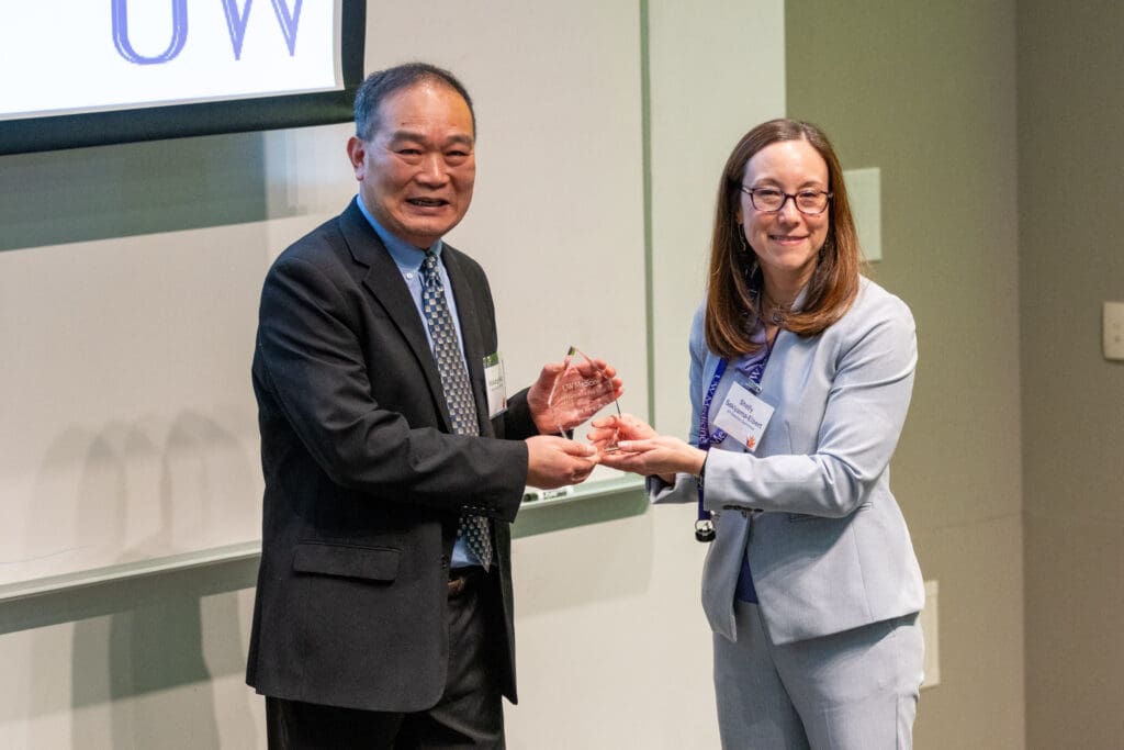A photo of Dr. Wang accepting the Inventor of the Year award
