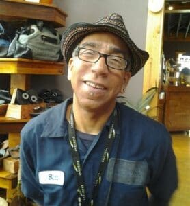 Smiling man wearing glasses and a hat